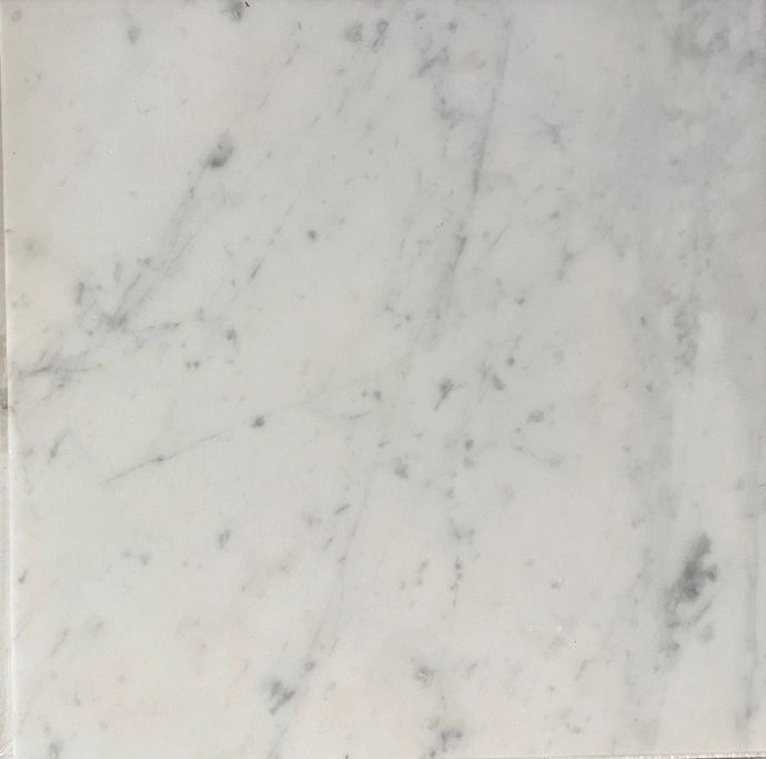 Carrara White Gioia marble 24×24 tile showing a soft white background with gray veining.
