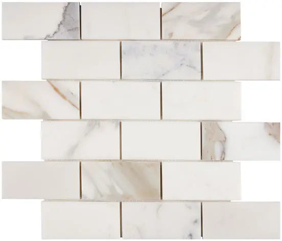 Calacatta Gold honed 2×4 brick marble mosaic.