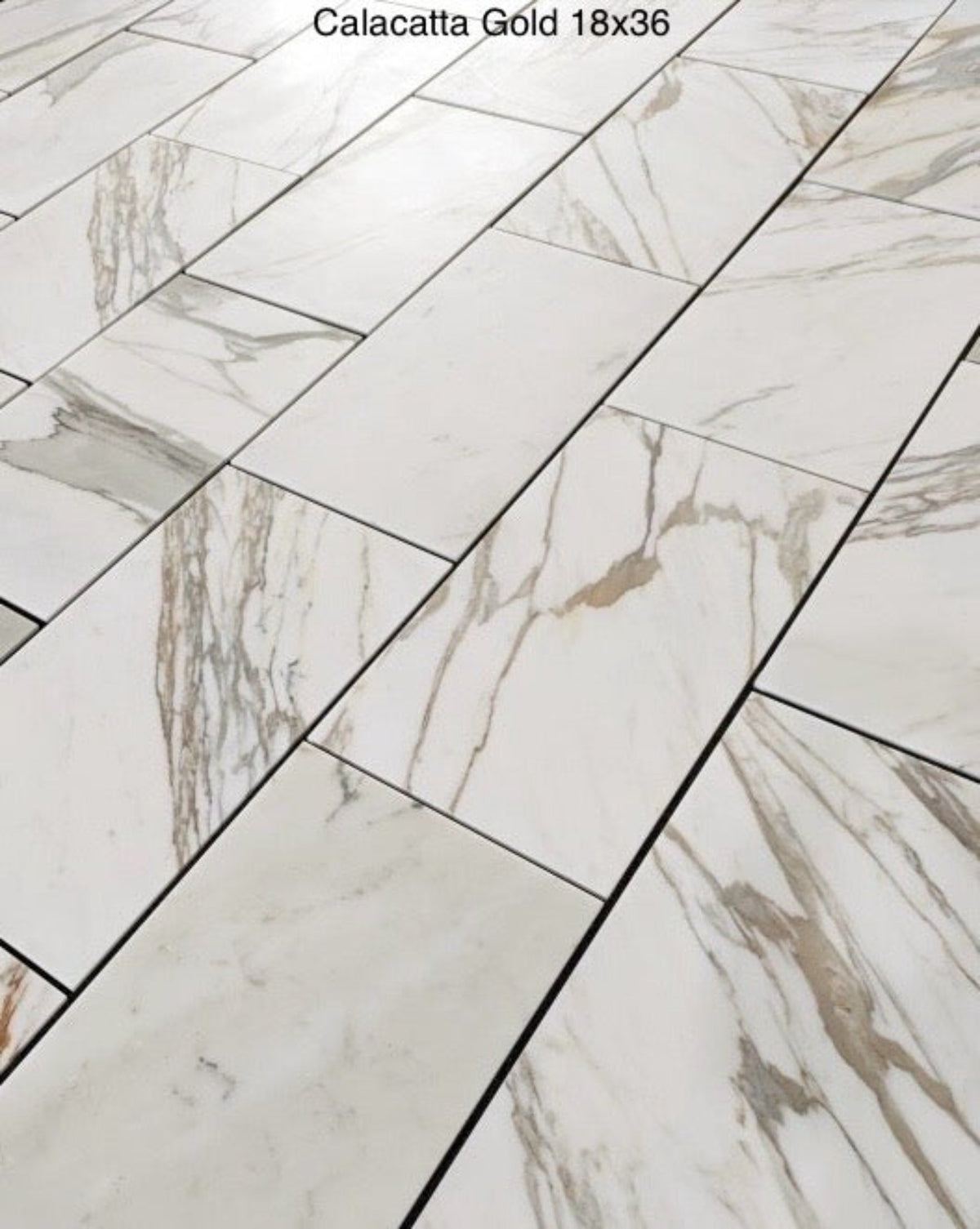 Calacatta Gold 18×36 inches marble tile with natural white, gray, and gold veining.