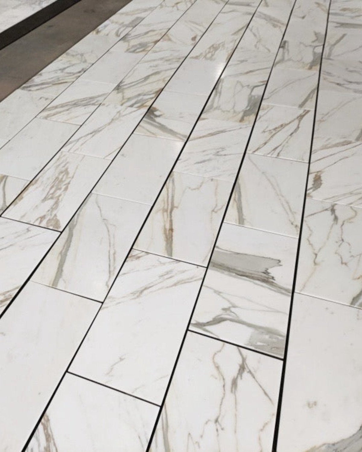 Calacatta Gold 18×36 inches marble tile with natural white, gray, and gold veining.