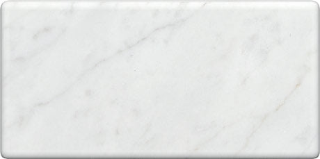 Carrara White Gioia marble 3×6 subway tile with a tumbled finish.