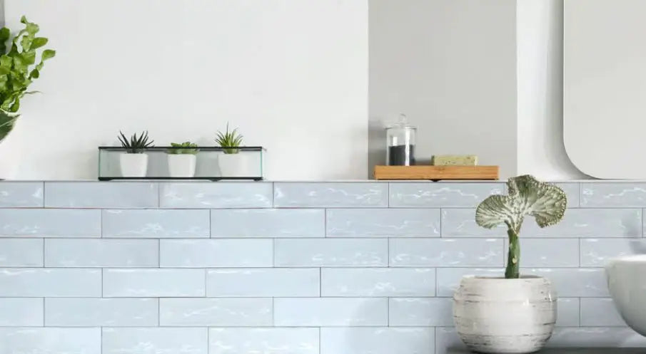Colina Azul Cielo glossy ceramic wall tile installed in a light-blue bathroom.