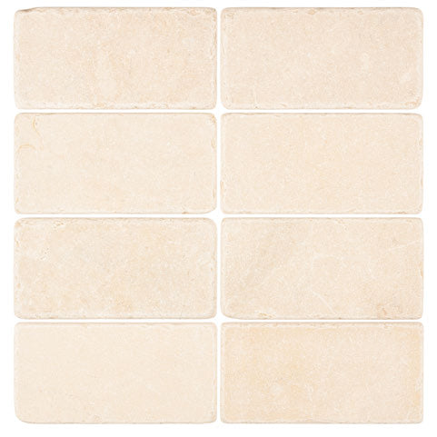 Crema Marfil marble 3×6 subway tile with a tumbled finish.