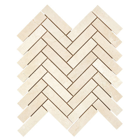 Crema Marfil marble 1×4 herringbone mosaic with a honed finish.