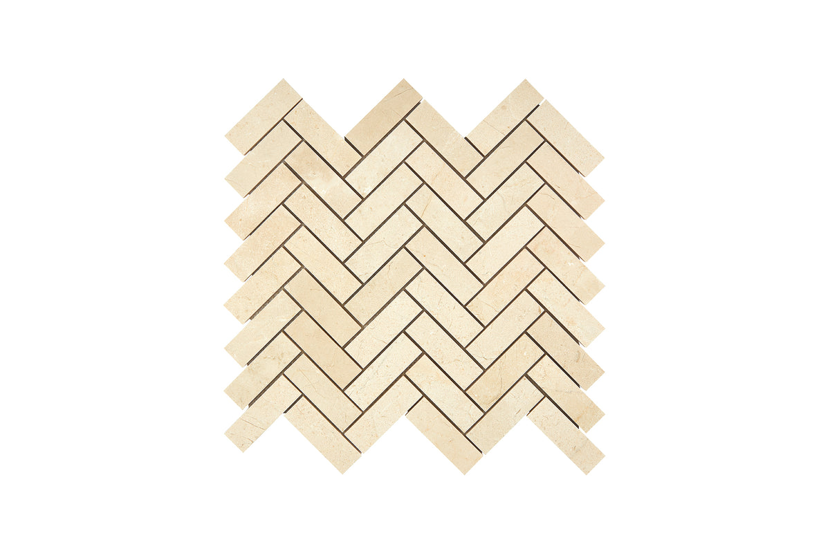 Crema Marfil marble 1×3 herringbone mosaic sheet in honed and polished finishes, warm beige with soft veining.