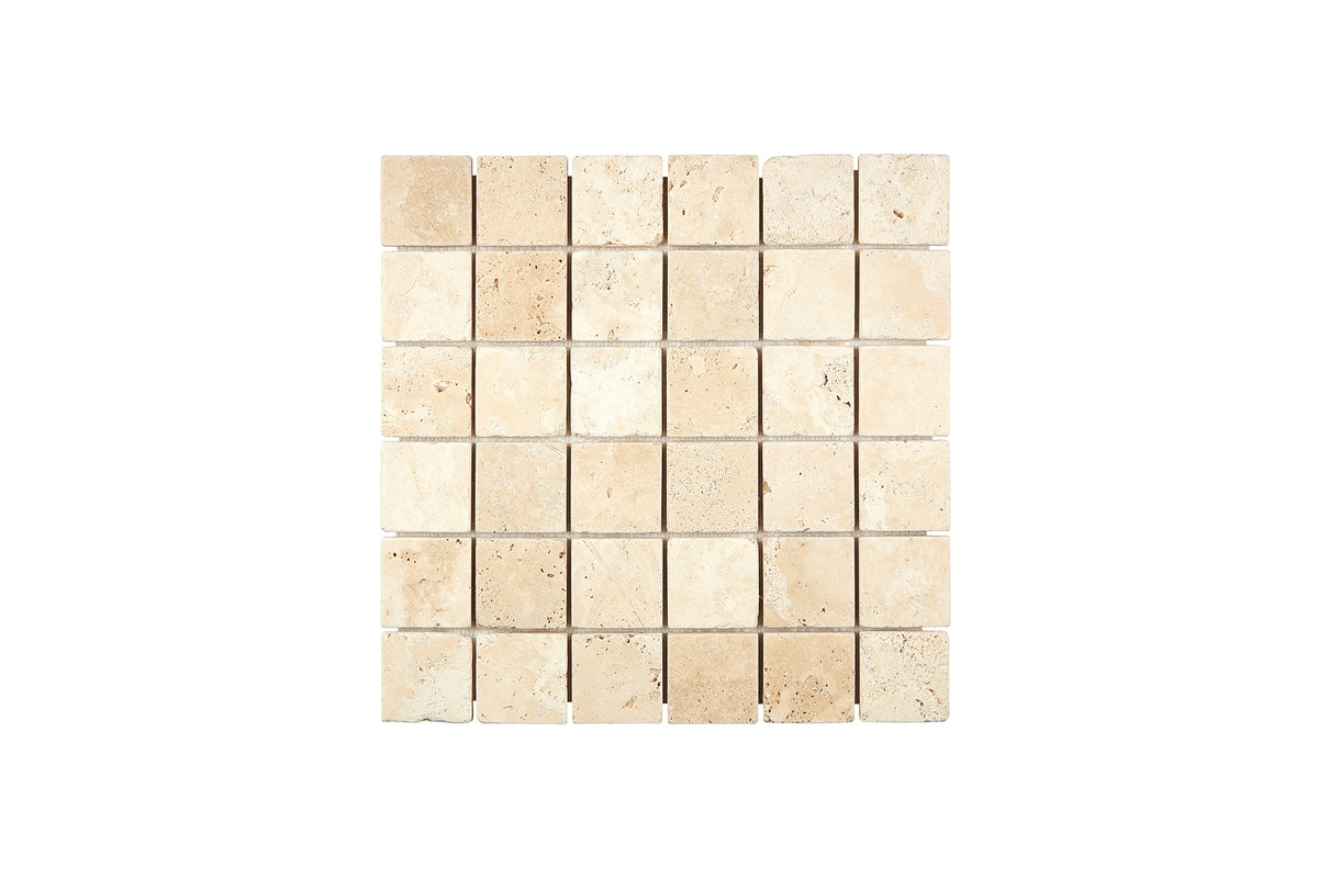 Ivory Travertine 2×2 mosaic sheet in a tumbled finish, warm ivory-beige natural stone.