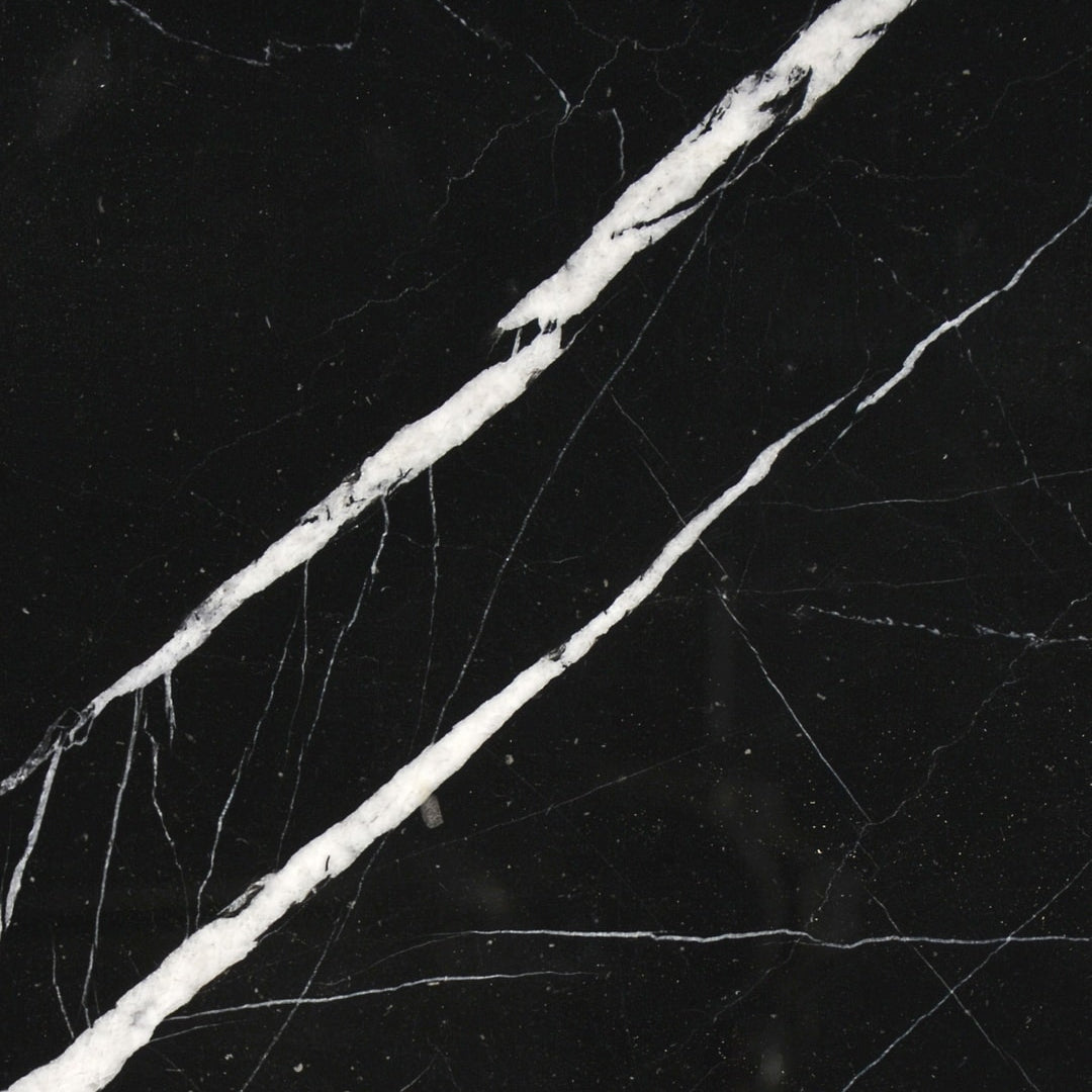 Nero Marquina marble 18×18 tile close-up, deep black stone with bold white veining.