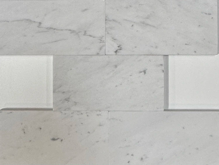 Carrara White Gioia marble 3×6 subway tile with a honed finish.
