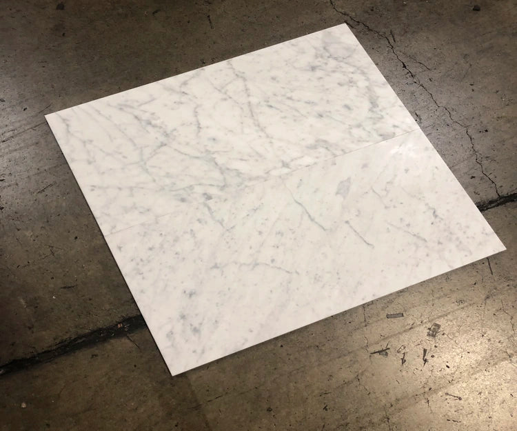 Carrara White Gioia marble 18×36 tiles dry-laid for designer inspection on a custom floor project.