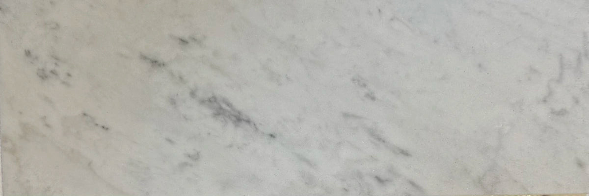 Carrara White Gioia marble 4×12 subway tile showing natural white and gray variation.