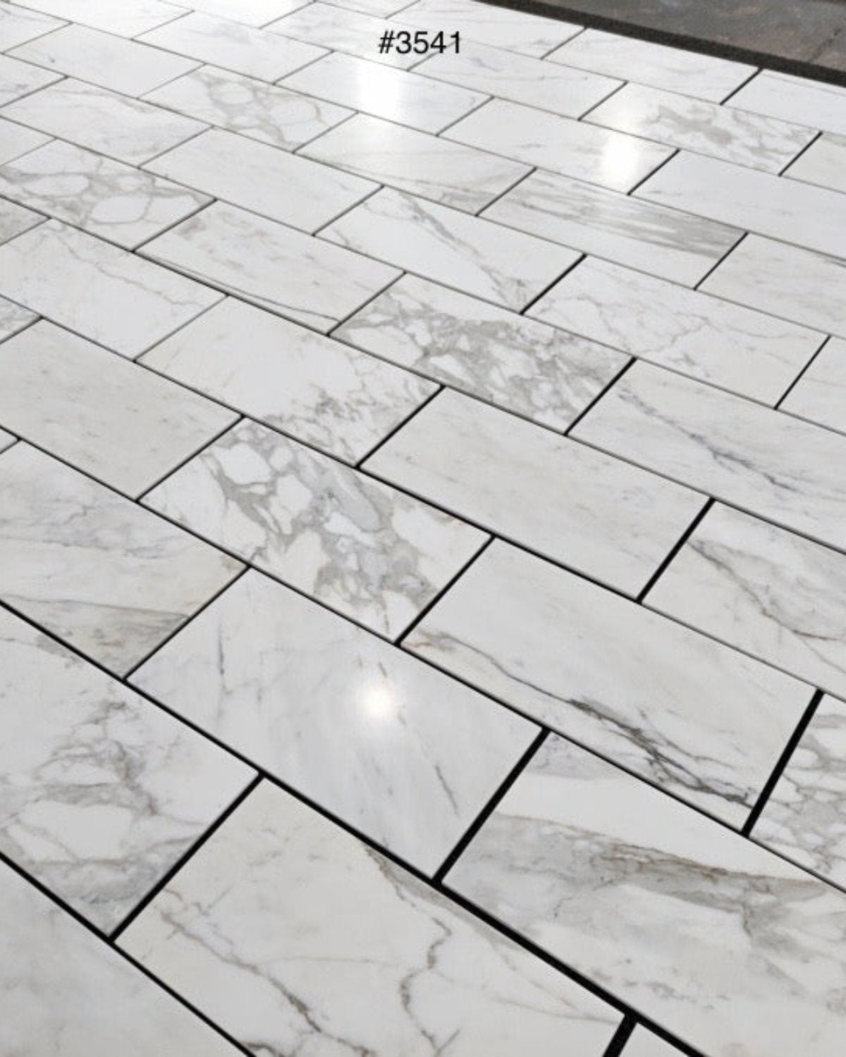 Calacatta Gold 12×24 inches marble tile with natural white, gray, and gold veining.