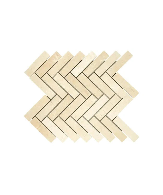 Crema Marfil marble 1×4 herringbone mosaic in a polished or honed finish.