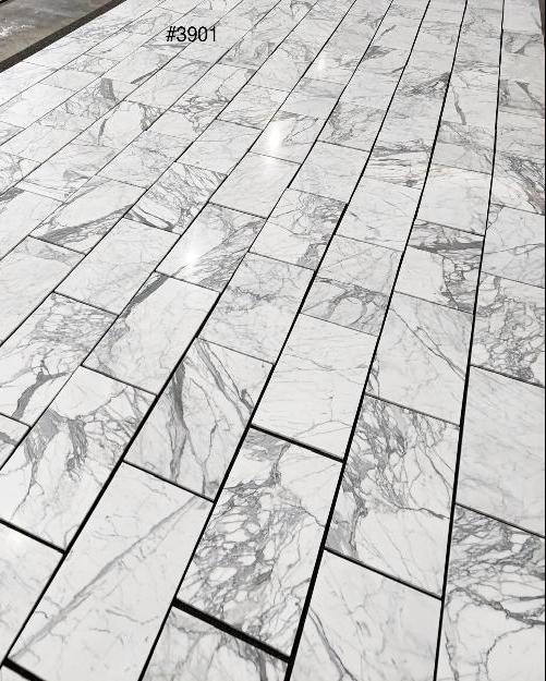 Statuary White marble 12×24 tile natural white and gray veining close-up.