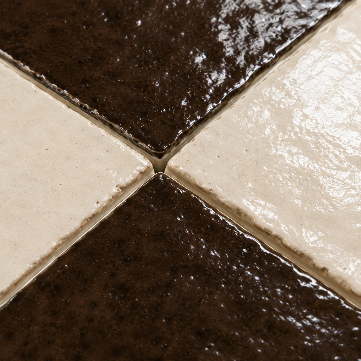 Close-up of Lucienne glossy Zellige checkerboard showing handmade glaze and edge variation, Espresso & Ivory.