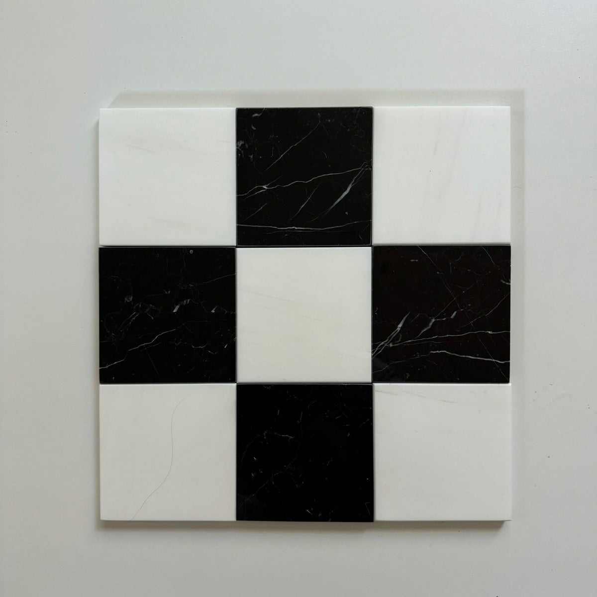 Bianco Dolomite & Nero Marquina multi-size polished or honed natural-stone checkerboard tile pattern.