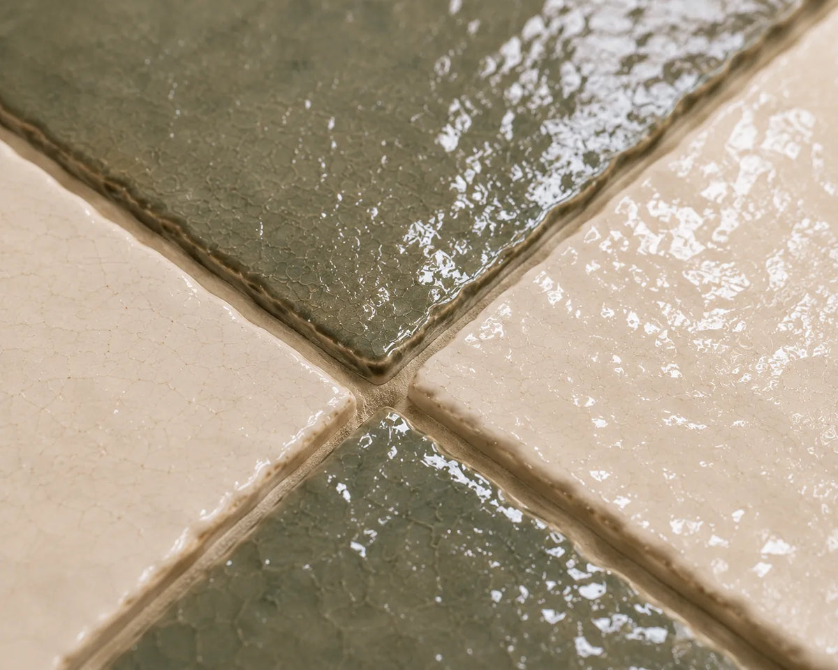 Close-up of Noémie glossy Zellige checkerboard showing handmade glaze and edge variation, Soft Sand & Ivory.