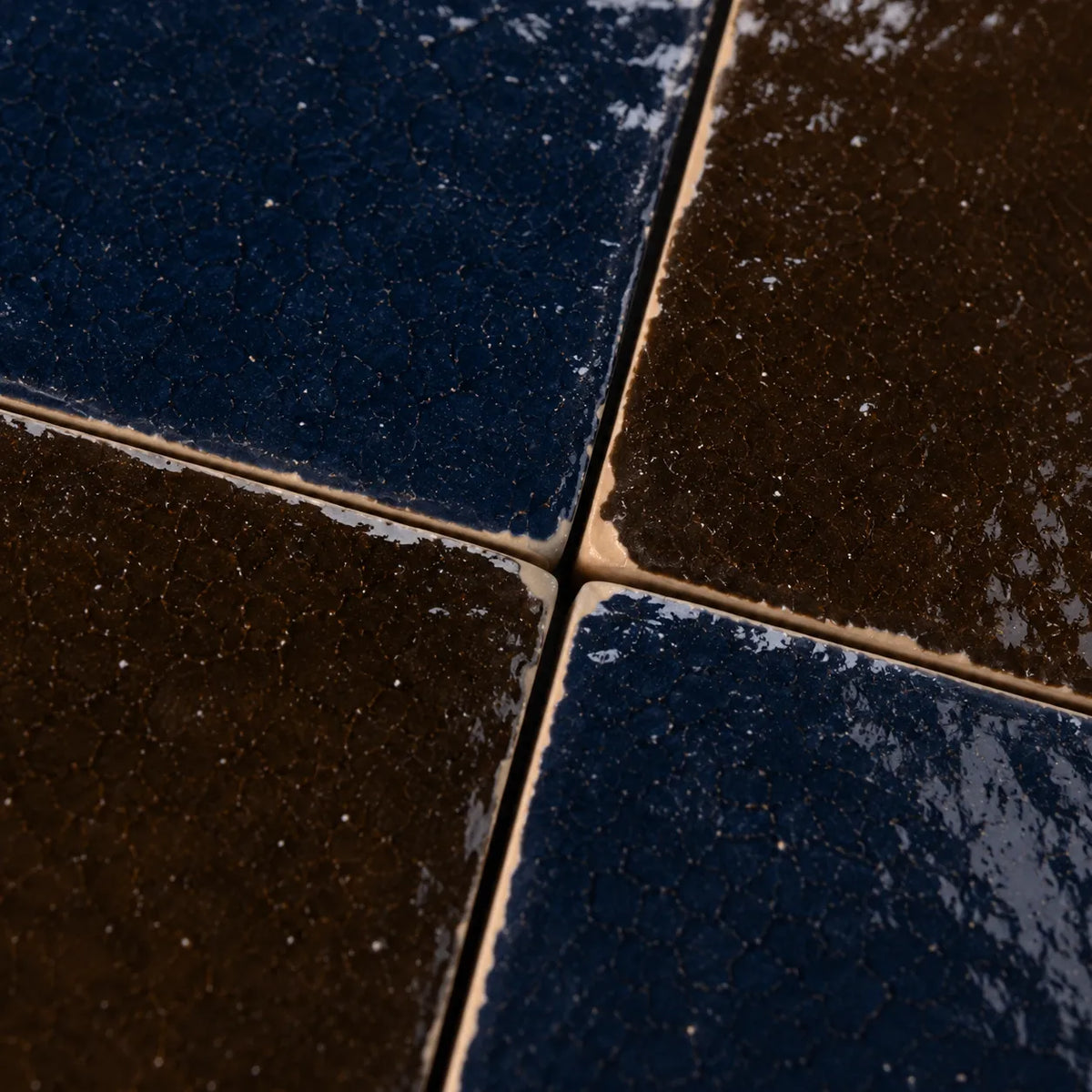 Close-up of Odette glossy Zellige checkerboard showing handmade glaze and edge variation, Indigo & Cacao.