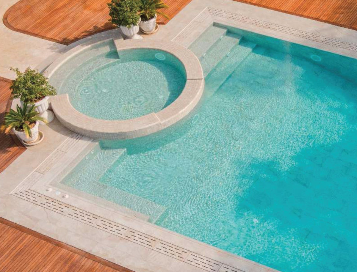 Beige Stone porcelain pool deck tile around a residential pool, project example