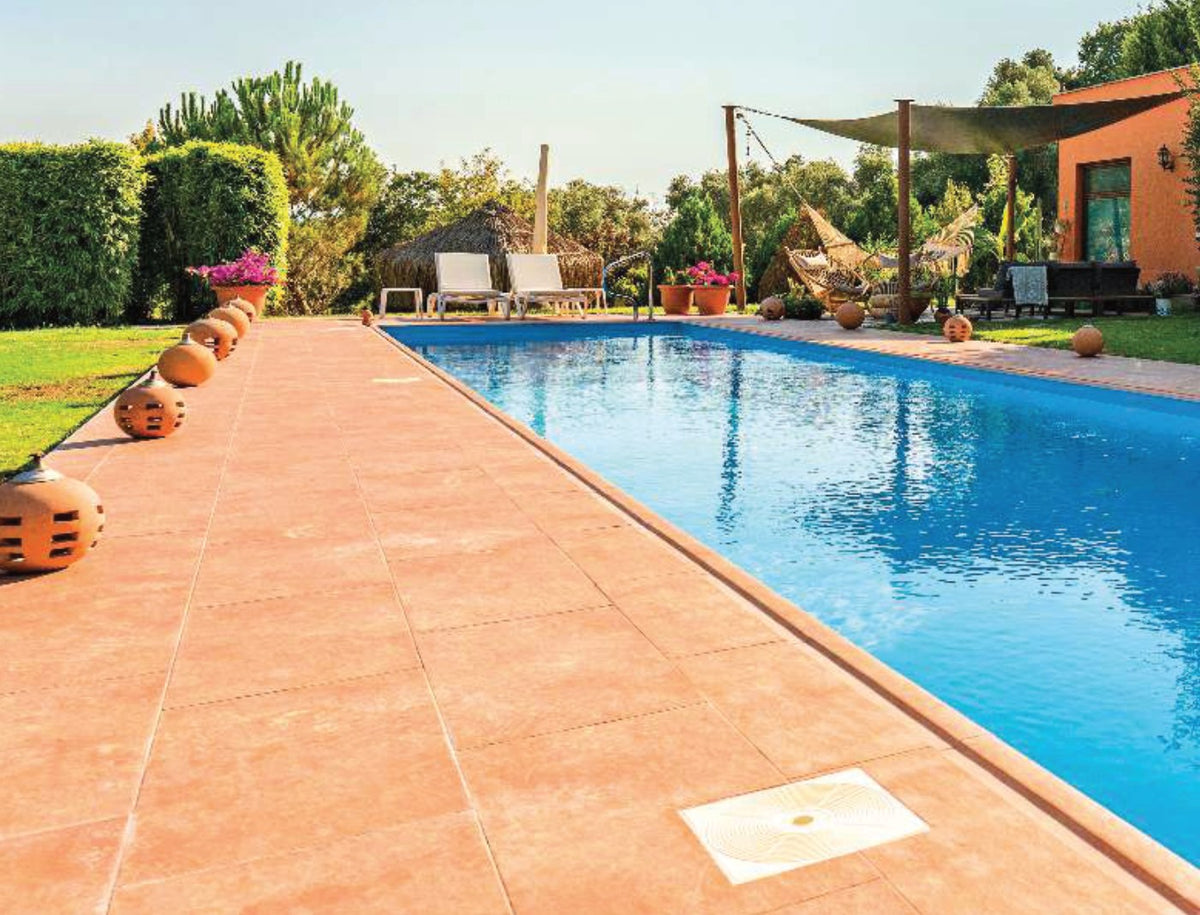 Cotto porcelain pool deck tile around a residential pool, project example