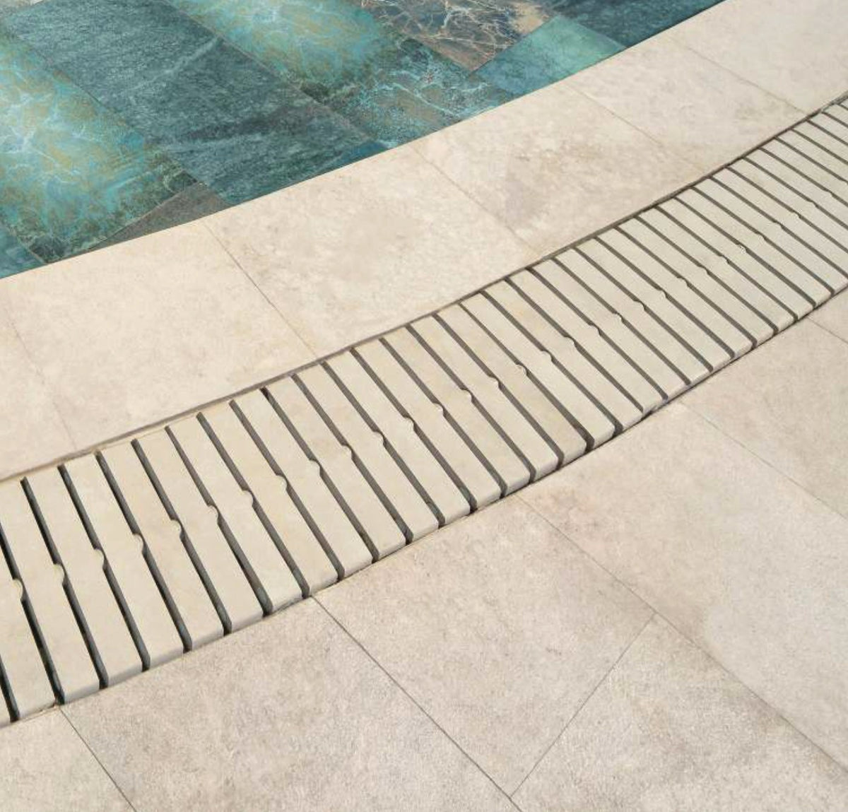Pool Garden Beige porcelain pool deck and coping at the pool edge