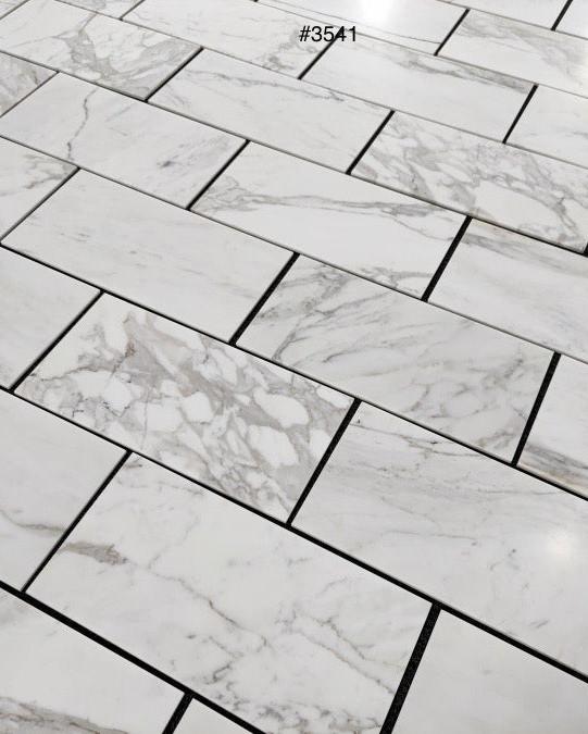 Calacatta Gold 12×24 inches marble tile with natural white, gray, and gold veining.
