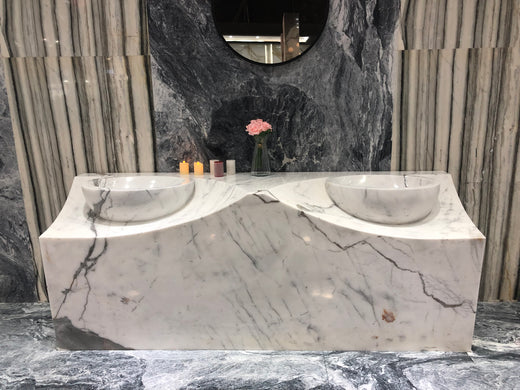 Trendy White Marble Double-Vanity top with distinctive veining and matching round marble bows