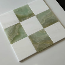 Green and white checkerboard tile floor in an elegant kitchen interior