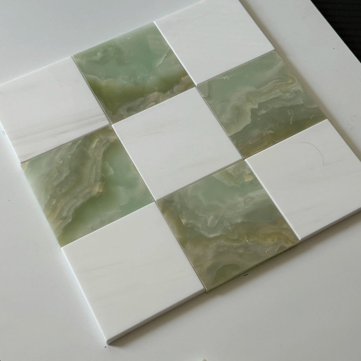 Green and white checkerboard tile floor in an elegant kitchen interior