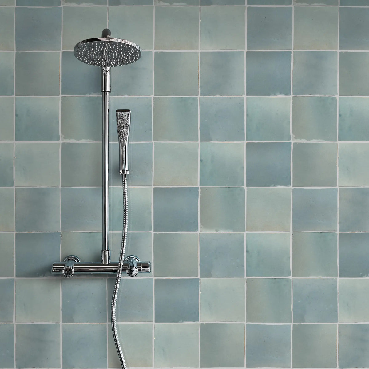 Aveline Aegean Blue 4×4 glazed ceramic mosaic installed on a shower wall