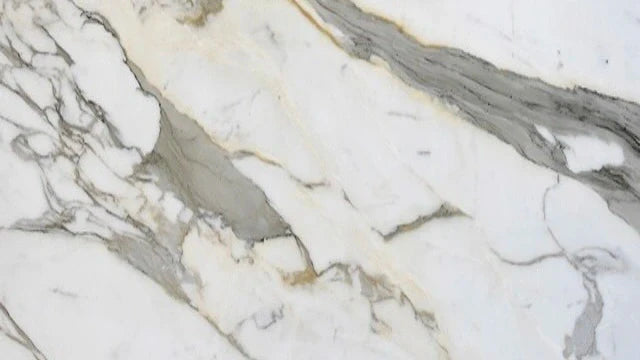 Calacatta Gold Italian Marble Tile featuring white background color with golden color veining 