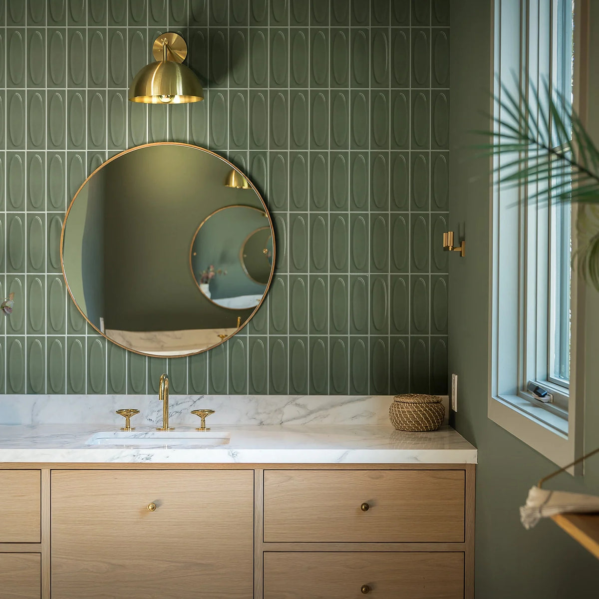 Vellora Sage Laurel 2×6 oval porcelain mosaic installed on a contemporary bathroom wall