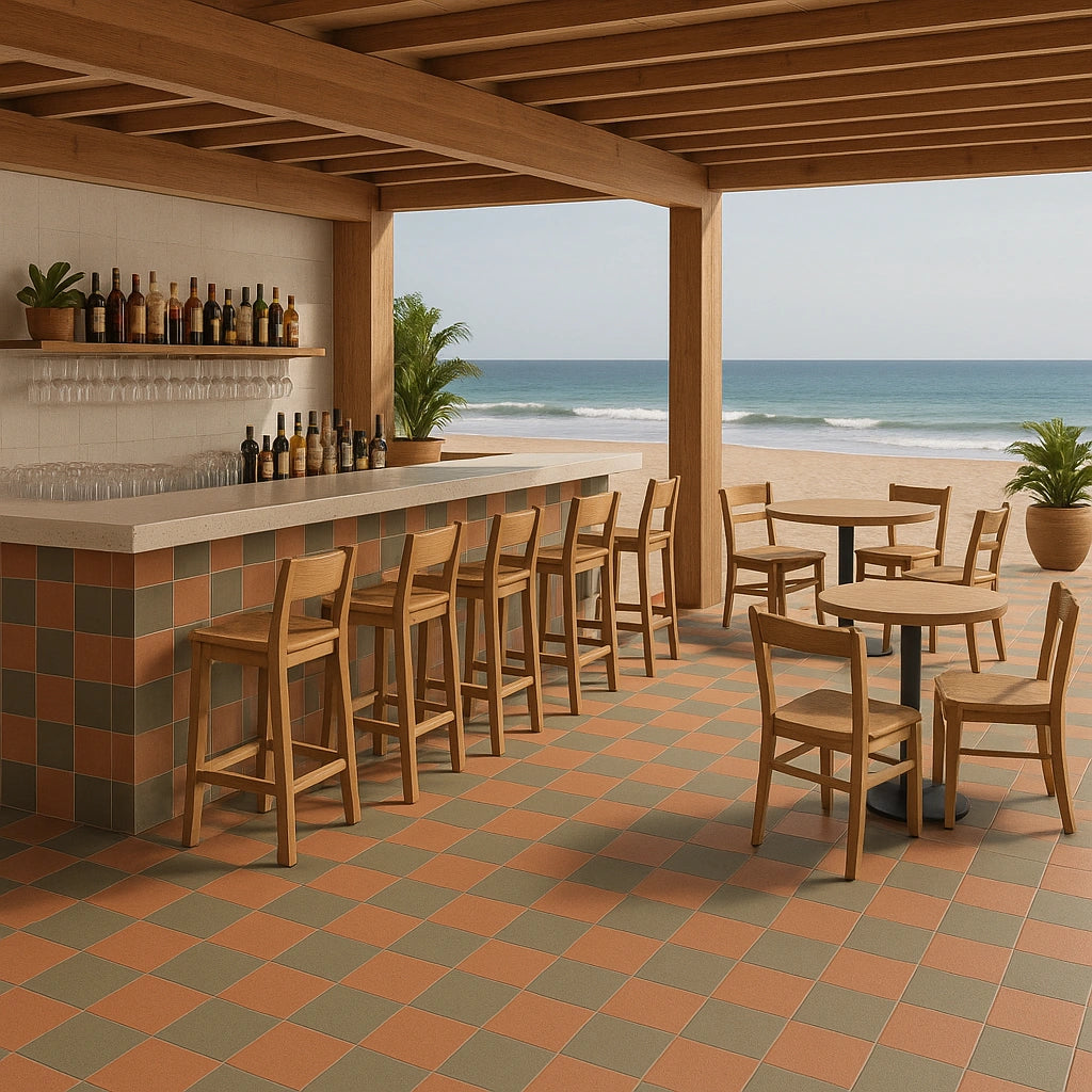Open beachfront bar with terracotta and olive checkerboard porcelain floor and wooden furniture.
