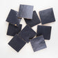 Nine indigo blue square zellige tiles on a white background