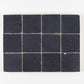 Dark blue zellige tiles arranged in a grid pattern on a white background