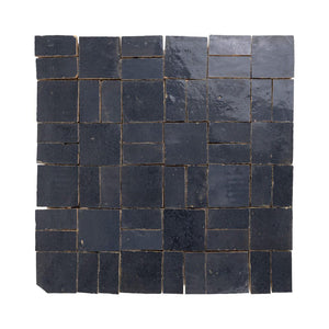 Zellige mosaic pattern of dark blue tiles on a white background