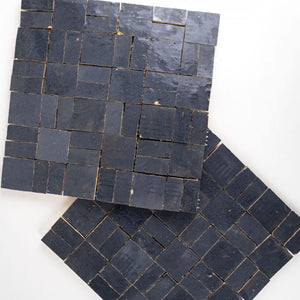 Dark blue zellige mosaic tiles on a white background