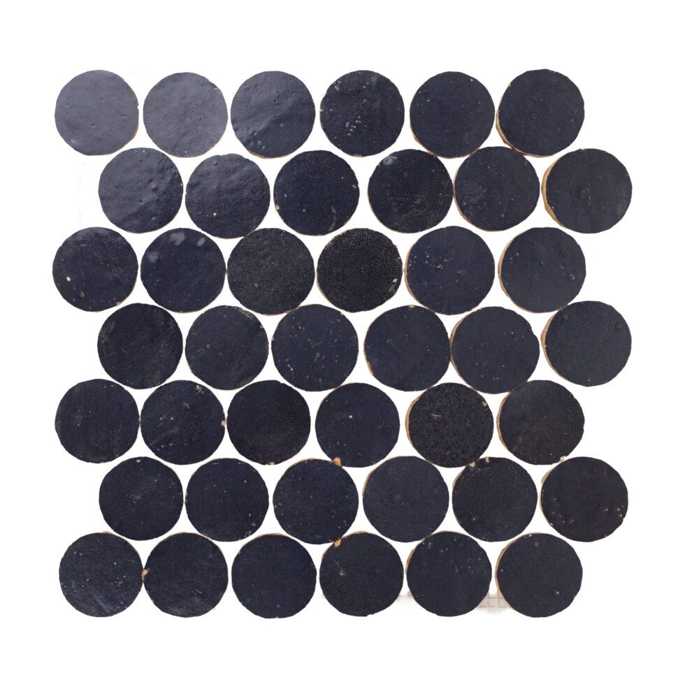 Indigo blue circular zellige mosaic tiles arranged in a grid pattern on a white background