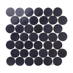 Indigo blue circular zellige mosaic tiles arranged in a grid pattern on a white background