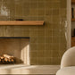 Aveline Amber Clay 4×4 semi-gloss ceramic mosaic installed on a contemporary fireplace wall