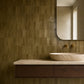 Aveline Amber Clay semi-gloss trapezoid ceramic mosaic installed behind a limestone bathroom vanity