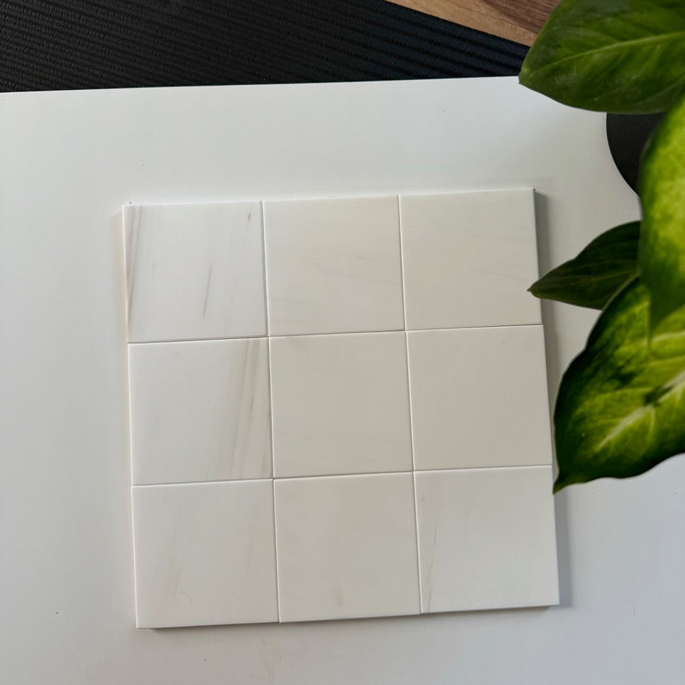 A detailed arrangement of  Bianco Dolomite tiles, highlighting their natural textures and neutral tones, ideal for luxurious bathroom or kitchen tiling projects.
