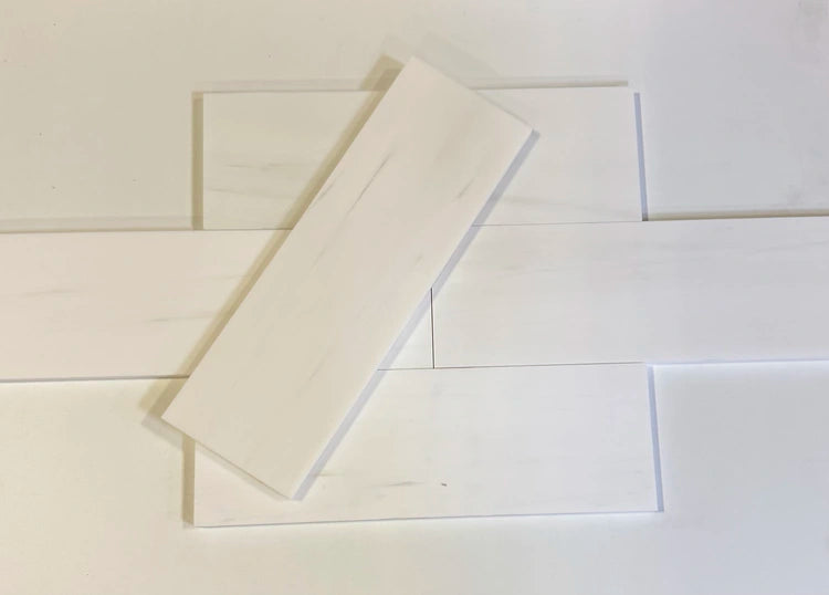 Bianco Dolomite 4x12 subway tiles in polished and honed finishes, arranged in a staggered layout for elegant interior designs.”