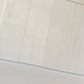 Bianco Dolomite 4x12 subway tiles aligned in a sleek vertical layout, showcasing their bright white tones and smooth finish.