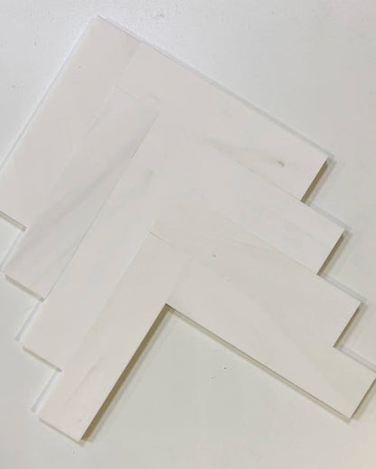 Bianco Dolomite marble tiles with a honed surface, arranged in a geometric pattern, perfect for kitchen or bathroom designs.