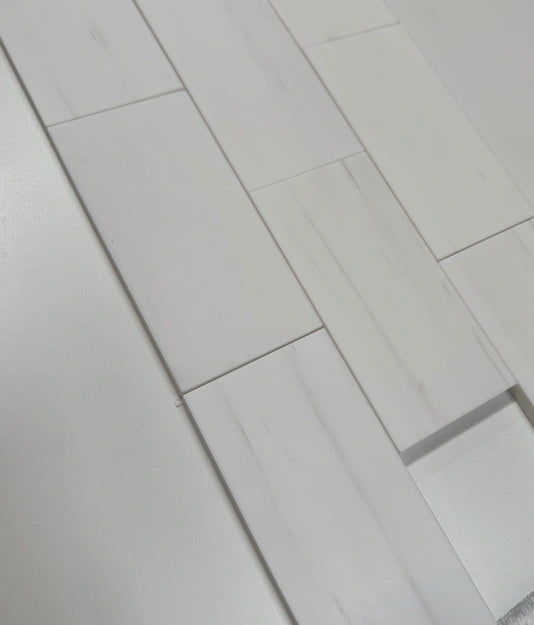 3x6 Bianco Dolomite marble tiles arranged in a staggered layout, showcasing their luxurious white tones and honed surface.