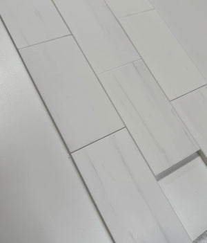 3x6 Bianco Dolomite marble tiles arranged in a staggered layout, showcasing their luxurious white tones and honed surface.