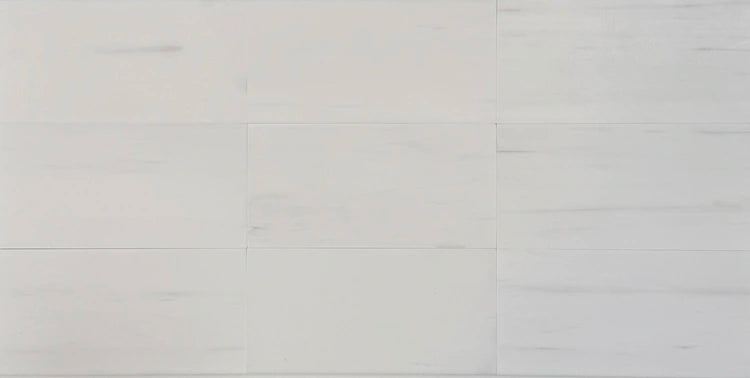 Polished and honed Bianco Dolomite 3x6 tiles, arranged for display, ideal for upscale kitchens, bathrooms, and commercial projects.