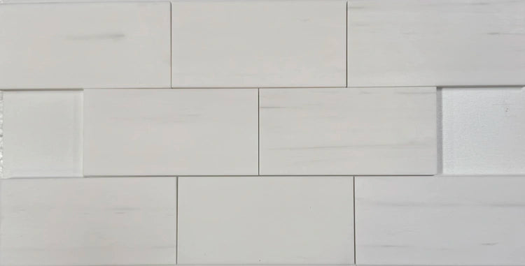 3x6 Bianco Dolomite marble tiles featuring soft veining and a polished finish, arranged in a staggered layout, showcasing their luxurious white tones