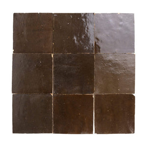 Square zellige tiles with a brown and gray pattern on a white background
