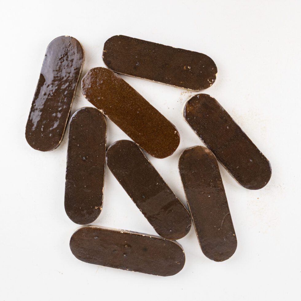 Brown oval-shaped zellige tiles on a white background